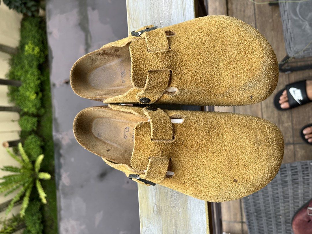 Birkenstock Boston Suede Clogs Taupe (Category: Slippers & Slides) located in Manila. Submitted by tanfinds (Listing ID 1464856849, Image 2). Description: - Item: Birkenstock Boston Clogs - Material: Genuine suede leather upper with classic cork footbed - Design: Slip-on style with adjustable strap and metal buckle - Condition: Pre-loved; shows minor marks on the toe, natural foot imprints on the footbed, and light tread wear on the heels - Perfe