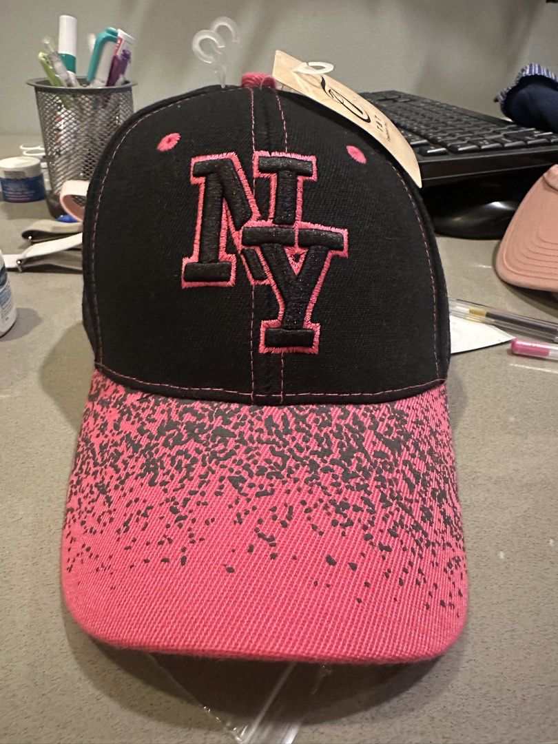 Black & Pink NY Embroidered Baseball Cap (Category: Caps & Hats) located in Makati City. Submitted by kobeskorner (Listing ID 1464919700, Image 1). Description: Black & Pink NY Embroidered Cap 🩷🖤 Brand new with tag Black cap with hot pink leopard-print brim Adjustable back Never worn.
