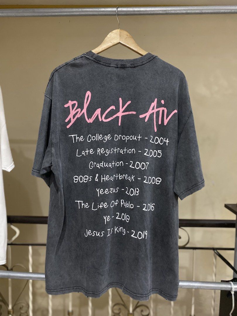 Black Air Global Spread Graphic Tee Size M (Category: Tshirts & Polo Shirts ) located in Rizal. Submitted by channzy (Listing ID 1464920263, Image 2). Description: - Brand: Made Extreme (Air Global Spread) - Color: Washed black/grey with heavy mineral wash finish - Size: M (Relaxed boxy fit) - Design: Vintage-style photo graphic with pink lettering on the front - Back Details: Complete Kanye West album list from The College Dropout to Jesus Is Ki