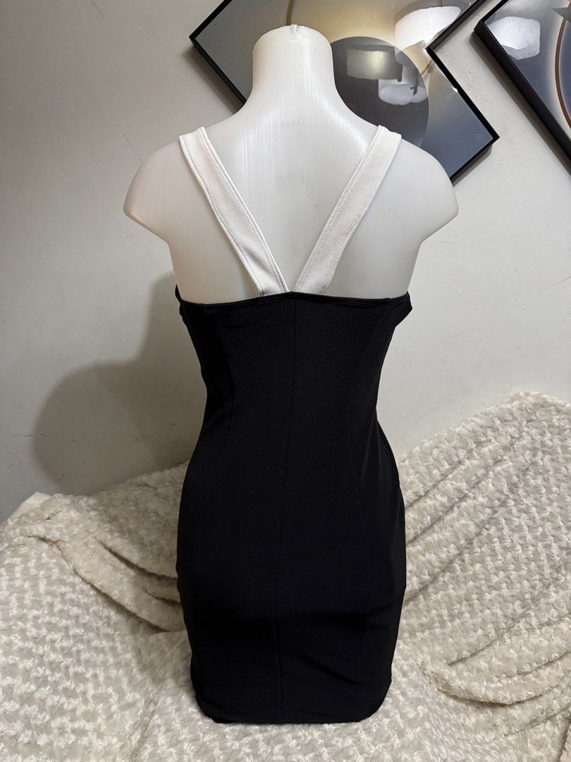 Black and White Bodycon Dress (Category: Dresses) located in Marikina City. Submitted by lorradel (Listing ID 1464832908, Image 3). Description: - Color: Classic black and white with slimming contrast side panels - Fit: Bodycon mini dress in a stretchy, curve-hugging ribbed fabric - Design: Scoop neckline with thick straps and a stylish criss-cross back detail - Occasion: Ideal for parties, clubbing, and nights out - Condition: Like new / Excelle