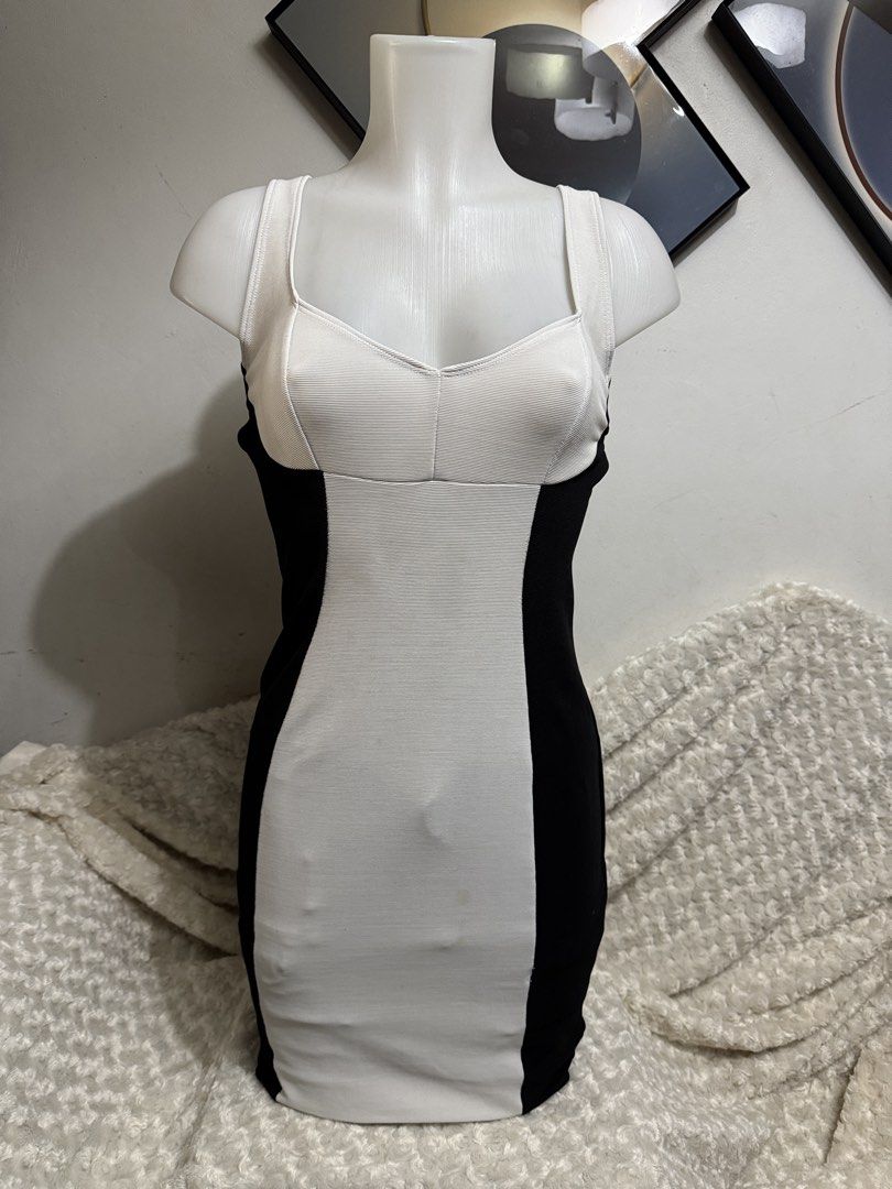 Black and White Bodycon Dress (Category: Dresses) located in Marikina City. Submitted by lorradel (Listing ID 1464832908, Image 1). Description: - Color: Classic black and white with slimming contrast side panels - Fit: Bodycon mini dress in a stretchy, curve-hugging ribbed fabric - Design: Scoop neckline with thick straps and a stylish criss-cross back detail - Occasion: Ideal for parties, clubbing, and nights out - Condition: Like new / Excelle