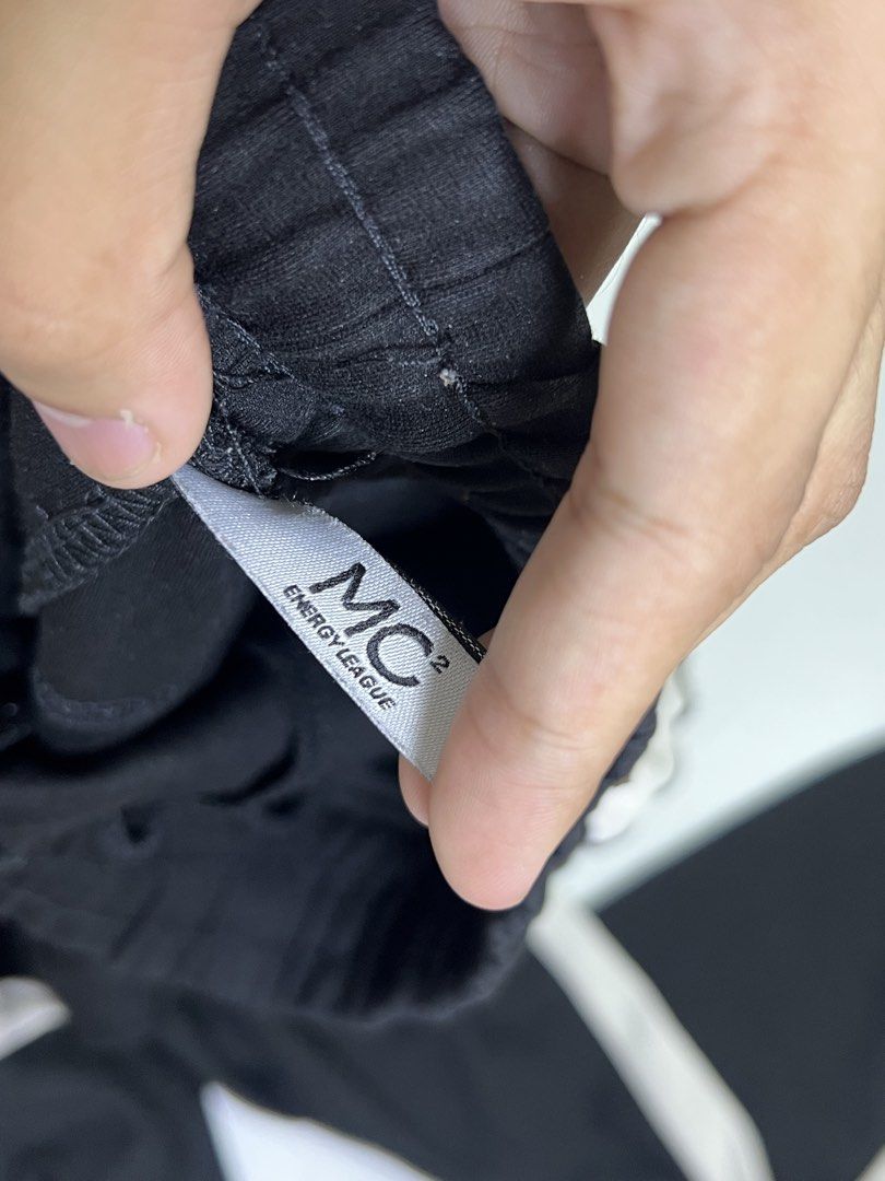 Black and White Jogger Sweatpants USE Text (Category: Joggers) located in Manila. Submitted by sennisen (Listing ID 1464922317, Image 3). Description: - Color: Black with white side stripes and text graphic near the pocket - Fit: Elastic waistband with adjustable black drawstring and cuffed ankles - Material: Soft, comfortable fabric ideal for everyday lounge wear - Condition: Noticeable stains and marks on the front thigh areas (priced according