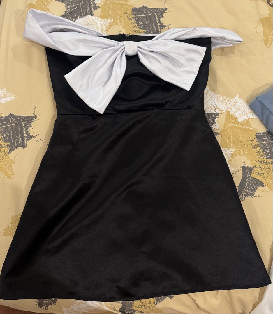 Black and White Off-Shoulder Bow Dress (Category: Dresses) located in Quezon City. Submitted by sonnythehedge (Listing ID 1464775204, Image 1). Description: - Color: Black with contrasting white off-shoulder sleeves - Design: Statement big front bow, fit and flare silhouette - Material: Satin-like fabric - Used once only! - Occasion: Ideal for dates, dinners, parties, and special events.
