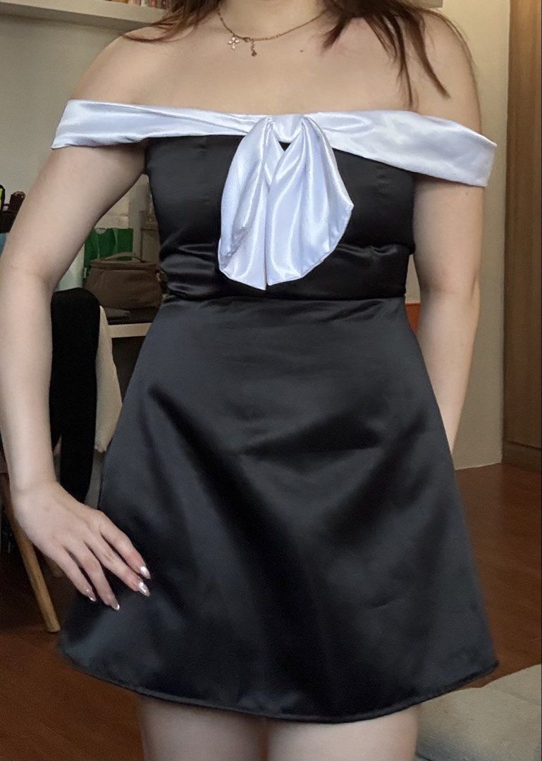 Black and White Off-Shoulder Bow Dress (Category: Dresses) located in Quezon City. Submitted by sonnythehedge (Listing ID 1464775204, Image 2). Description: - Color: Black with contrasting white off-shoulder sleeves - Design: Statement big front bow, fit and flare silhouette - Material: Satin-like fabric - Used once only! - Occasion: Ideal for dates, dinners, parties, and special events.