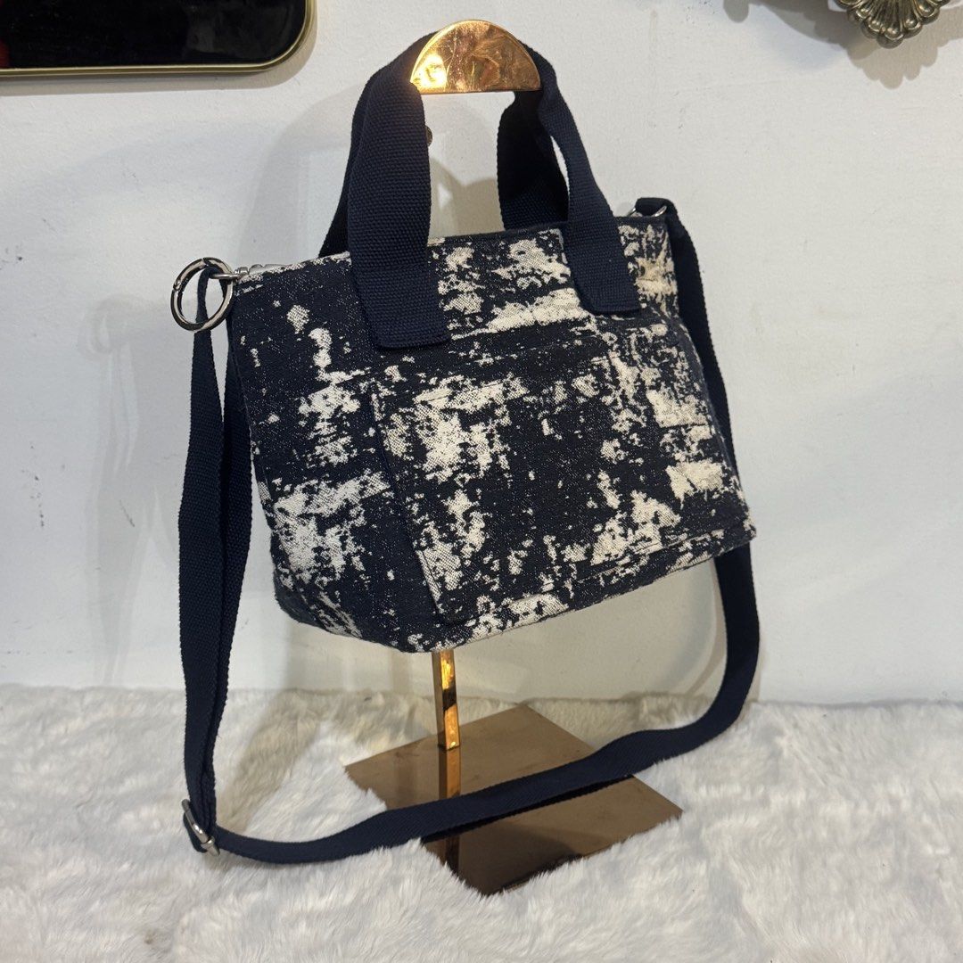 Rootote mini Tote Bag with Strap (Category: Tote Bags) located in Rizal. Submitted by houseofbell (Listing ID 1464947174, Image 2). Description: - Textured canvas tote with a trendy black and white abstract pattern - Dual navy blue top handles and an adjustable matching shoulder strap - Secure top zipper closure with metal hardware detail - Spacious interior with a clean fabric lining, perfect for daily essentials Excellent condition Likenew.