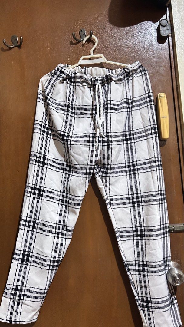 Black and white plaid pajama pants drawstring waist (Category: Jeans) located in Cabuyao City. Submitted by pickedbyarya (Listing ID 1464832444, Image 1). Description: Size S-M W 11 x 32 in Medyo stretchy naman yung sa waist - Classic black and white plaid design - Comfortable elastic waistband with white drawstring - Relaxed straight-leg fit for ultimate ease - Soft and breathable cotton-blend fabric - Ideal for sleeping, lounging, or working fr