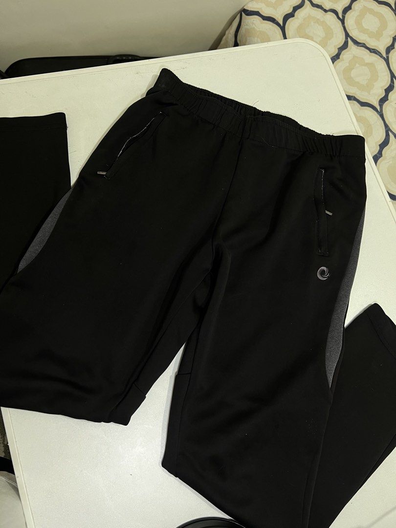 Black Athletic Track Pants with Zipper Pockets (Category: Joggers) located in Manila. Submitted by sennisen (Listing ID 1464922584, Image 1). Description: - Color: Black with stylish grey side panels - Fit: Comfortable elastic waistband for all-day wear - Storage: Two front zippered pockets to keep your essentials safe - Material: Lightweight fabric designed for easy movement - Details: Features a small swirl logo near the left pocket with clean 