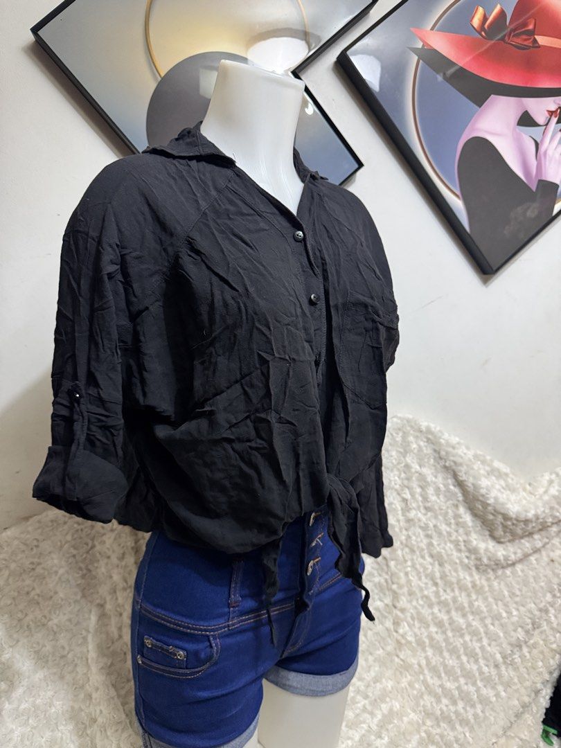 Black long sleeve button down tied front shirt blouse (Category: Longsleeves) located in Marikina City. Submitted by lorradel (Listing ID 1464897032, Image 2). Description: - fits M-L - Color: Black - Style: Button-down blouse with front tie detail - Sleeves: Long sleeves with rolled-up tab and button fasteners - Neckline: Classic collar - Fit: Relaxed fit in lightweight fabric - Versatility: Easy to pair with denim shorts or high-waisted jeans f