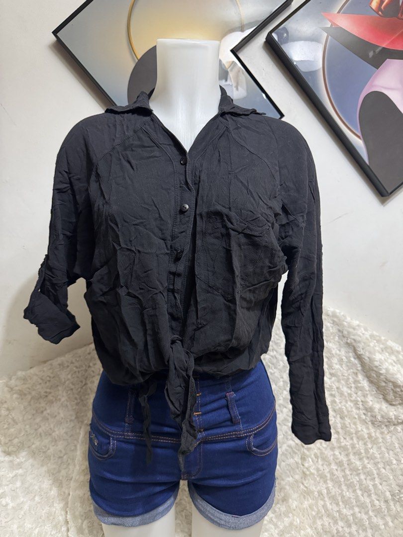 Black long sleeve button down tied front shirt blouse (Category: Longsleeves) located in Marikina City. Submitted by lorradel (Listing ID 1464897032, Image 1). Description: - fits M-L - Color: Black - Style: Button-down blouse with front tie detail - Sleeves: Long sleeves with rolled-up tab and button fasteners - Neckline: Classic collar - Fit: Relaxed fit in lightweight fabric - Versatility: Easy to pair with denim shorts or high-waisted jeans f