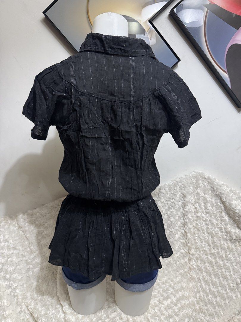Black metallic pinstripe button-up blouse with peplum hem (Category: Blouses) located in Marikina City. Submitted by lorradel (Listing ID 1464897775, Image 3). Description: - Color: Black with delicate silver pinstripes - Style: Collared neckline, front button closure, and flattering peplum waist - Fabric: Soft, textured crinkle material - Fit: Short sleeves, gathered bodice - Versatility: Easy to dress up with a skirt or keep casual with jeans -