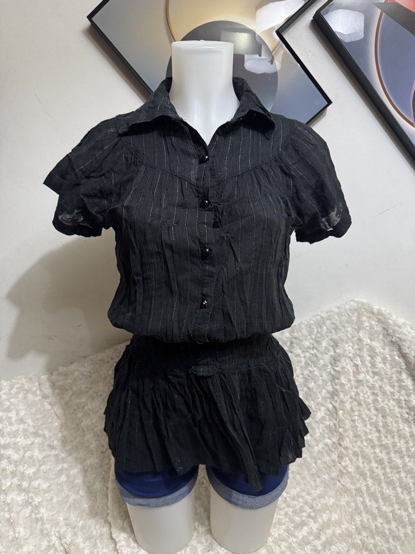 Black metallic pinstripe button-up blouse with peplum hem (Category: Blouses) located in Marikina City. Submitted by lorradel (Listing ID 1464897775, Image 1). Description: - Color: Black with delicate silver pinstripes - Style: Collared neckline, front button closure, and flattering peplum waist - Fabric: Soft, textured crinkle material - Fit: Short sleeves, gathered bodice - Versatility: Easy to dress up with a skirt or keep casual with jeans -