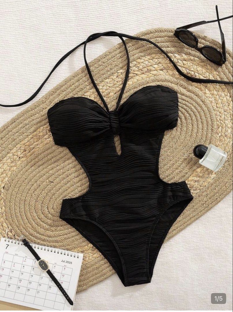 Black One piece (Category: Bikinis & Swimsuits) located in Imus. Submitted by thia14 (Listing ID 1464791546, Image 2). Description: - Color: Black - Fabric: Textured ribbed material all over - Design: Halter neck tie-up, waist cut-outs, and center bust keyhole detail - Cut: Flattering high-cut leg design - Perfect for: Beach trips, pool days, and summer vacations.