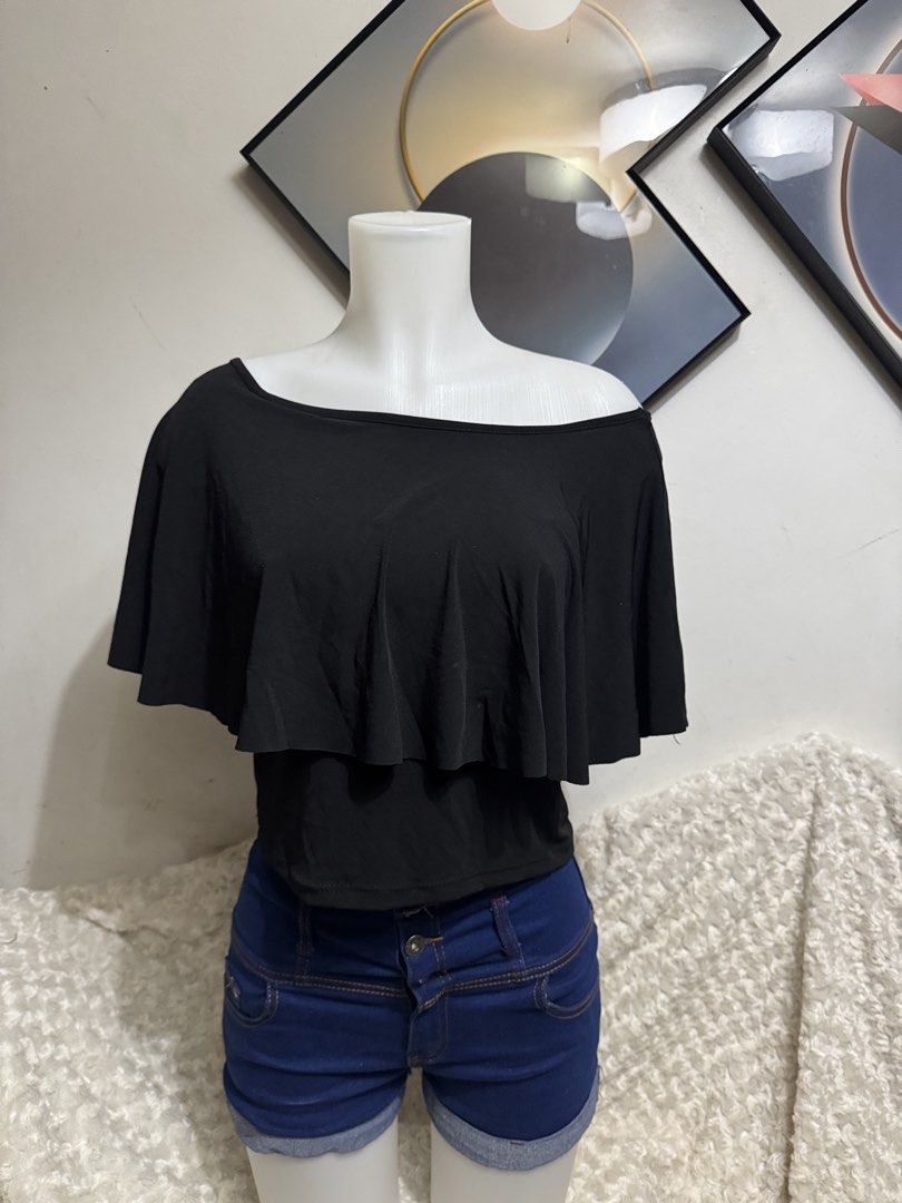 Black One-Shoulder Ruffle Overlay Crop Top (Category: Sleeveless) located in Marikina City. Submitted by lorradel (Listing ID 1464905474, Image 2). Description: - Color: Black - Style: Off-shoulder short sleeve top with a draped chest ruffle - Fit: Snug, body-hugging fit with stretchy fabric for comfort - Design: Easy pull-on style - Pairing: Looks great with high-waisted denim shorts - MAY HAVE some washable stains (hindi maiiwasan) needs washin