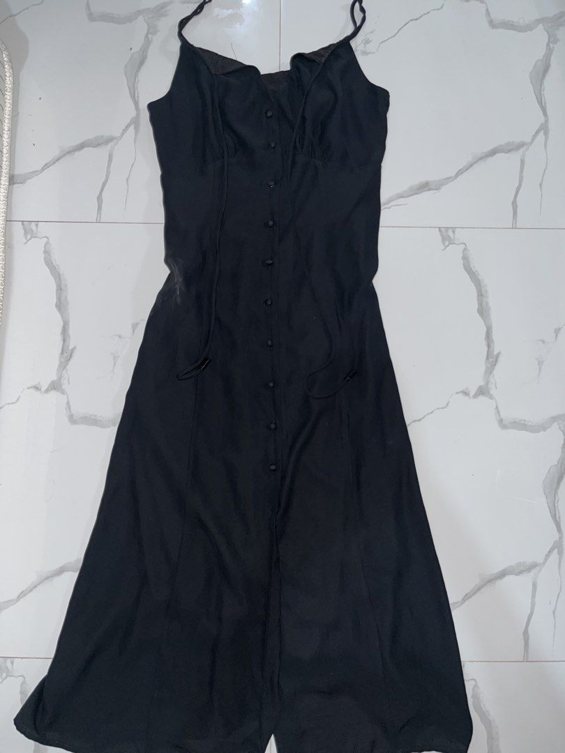 Black sleeveless button-front midi dress with spaghetti straps (Category: Dresses) located in Manila. Submitted by amycol.ph (Listing ID 1464780396, Image 1). Description: - Color: Classic Black - Length: Midi - Design: Thin spaghetti straps and full front button-down closure - Fit: Fitted bodice with a slightly flared skirt - Fabric: Lightweight and versatile for day-to-night wear.