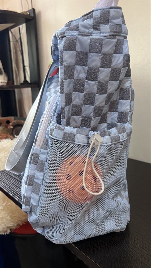 Blue and grey checkered pickleball tote bag (Category: Tote Bags) located in Manila. Submitted by kendsg (Listing ID 1464942528, Image 2). Description: - Stylish blue and grey checkered design - Spacious main compartment for all your gear - Dedicated paddle sleeve slot for secure storage - Multiple outside zippered pockets and compartments for organization - Mesh side pocket with drawstring toggle to hold balls safely - Equipped with convenient c