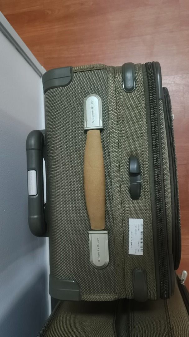 Briggs & Riley Baseline Global/Essential Expandable Carry-On Spinner (Olive) (Category: Luggage) located in Makati City. Submitted by kiwi_thetuxedocat (Listing ID 1464799040, Image 2). Description: Selling a premium Briggs & Riley Baseline Expandable Carry-On Spinner suitcase in their iconic olive green color with classic leather accents. Widely regarded by frequent flyers, pilots, and business travelers as the absolute best carry-on money can b