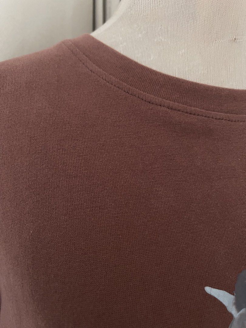 Brown Graphic Tee (Category: Shirts) located in Cainta. Submitted by zlove111 (Listing ID 1464807290, Image 3). Description: - Color: Brown - Design: Renaissance-style angel graphic with 'FROM' text on the chest - Fit: Relaxed fit with a classic crew neck - Material: Soft, cotton knit - Style: Versatile staple for casual everyday outfits large .