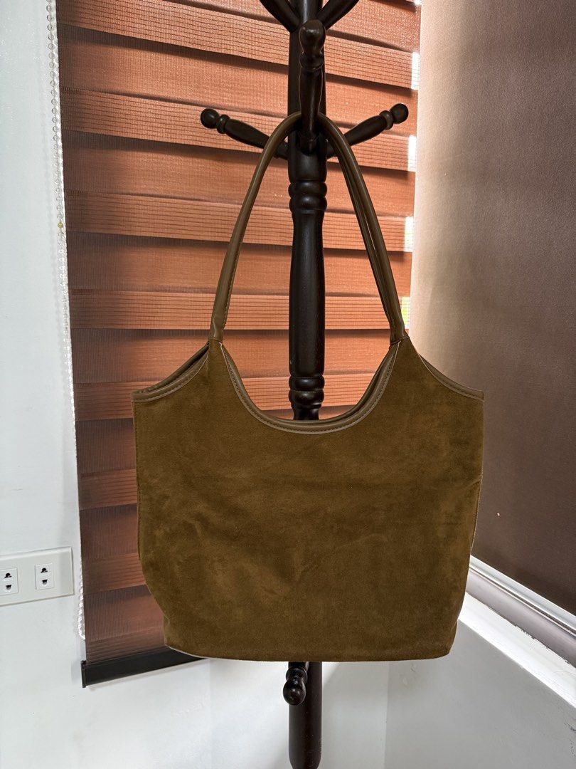 Brown suede shoulder bag with leather straps (Category: Shoulder Bags) located in Imus. Submitted by neirasalonga_ (Listing ID 1464790721, Image 1). Description: - Stylish brown suede shoulder bag, perfect for everyday wear - Features faux leather handles, top trim, and stitched strap details - Spacious main compartment to fit all your daily essentials - Flaw/Condition note: Some wear and splitting on the handle stitching near the base (please ch