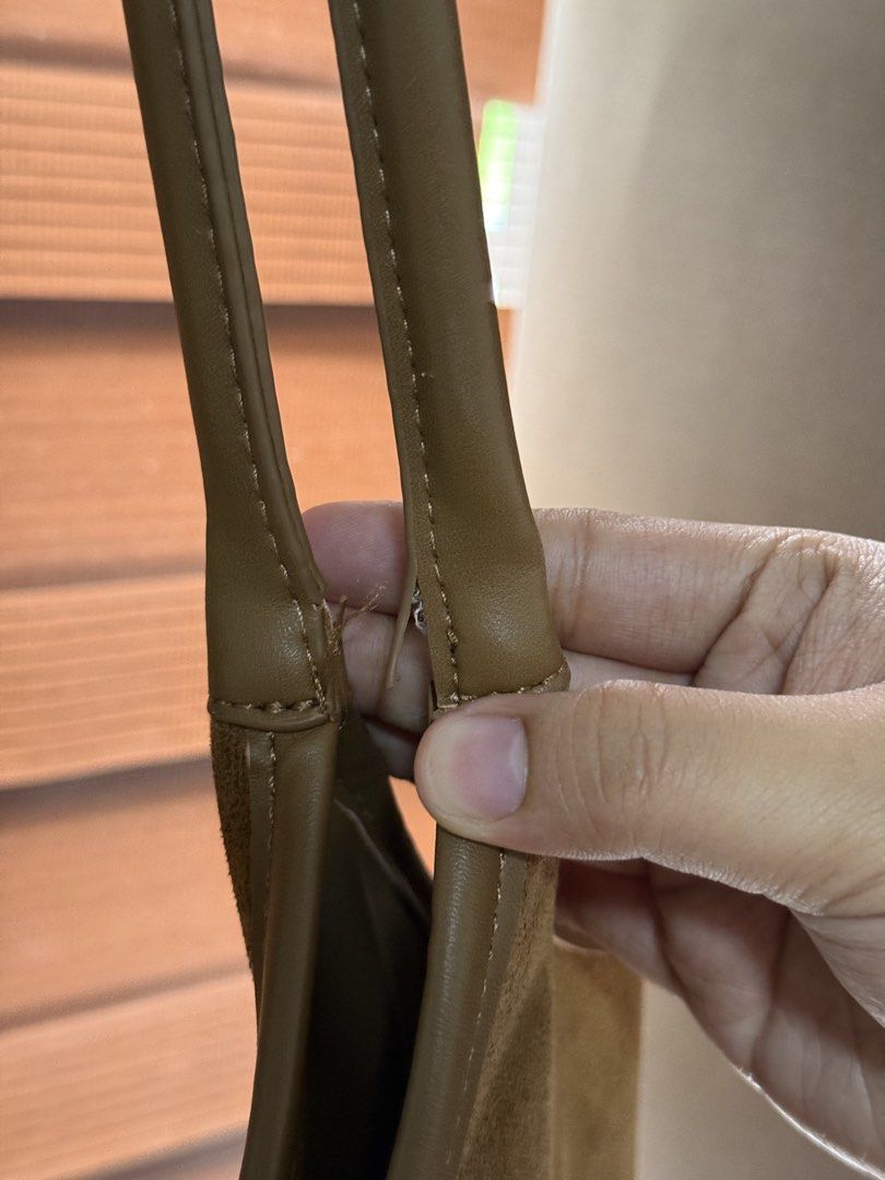Brown suede shoulder bag with leather straps (Category: Shoulder Bags) located in Imus. Submitted by neirasalonga_ (Listing ID 1464790721, Image 3). Description: - Stylish brown suede shoulder bag, perfect for everyday wear - Features faux leather handles, top trim, and stitched strap details - Spacious main compartment to fit all your daily essentials - Flaw/Condition note: Some wear and splitting on the handle stitching near the base (please ch