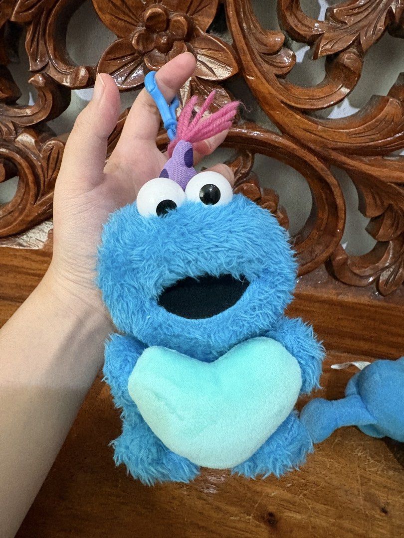 BUNDLE Cookie Monster plush toy keychain (Category: Plushies & Soft Toys) located in Quezon City. Submitted by rxyel (Listing ID 1464779973, Image 2). Description: - Set of 2 Sesame Street Cookie Monster plush keyclips - Includes fuzzy monster with party hat holding a light blue heart - Features rare vintage 1995 Tyco smooth plush toy - Both items are soft, clean, and come with intact original tags - Great retro collectibles for fans and collecto