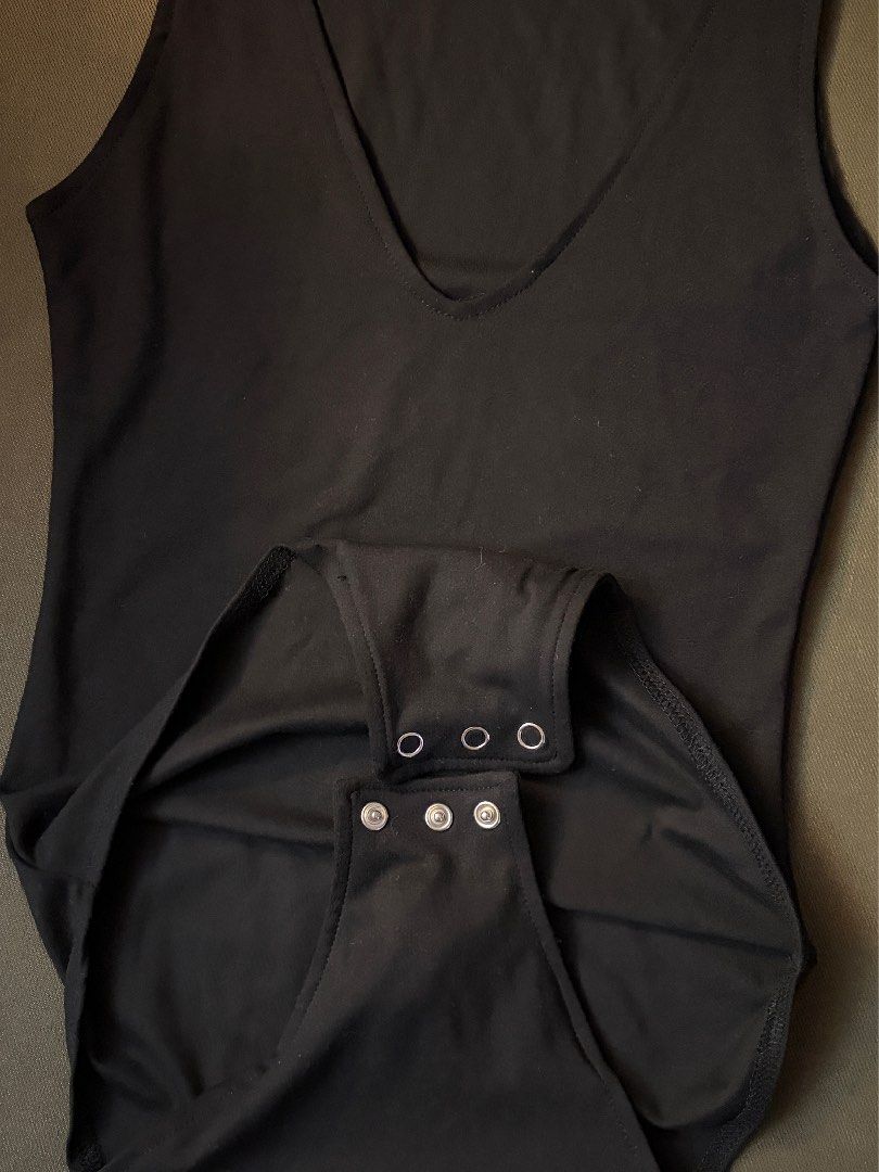 Candy Black Sleeveless V-Neck Bodysuit Extra Small (Category: Sleeveless) located in Dasmarinas. Submitted by fionaornopia (Listing ID 1464891471, Image 2). Description: - Brand: Candy - Style: Sleeveless bodysuit with deep V-neckline - Size: Extra Small (XS) - Color: Classic Black - Closure: Convenient snap buttons at the bottom - Material: Soft and stretchy fabric - Condition: Excellent basic piece, perfect for layering.