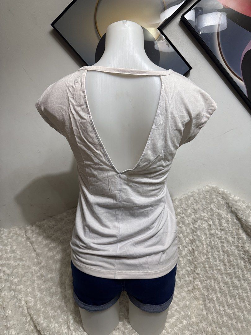Cap Sleeve Top with Open Back (Category: Shirts) located in Marikina City. Submitted by lorradel (Listing ID 1464901089, Image 3). Description: - fits S-M - Fabric: Soft, comfy cotton - Design: Scoop neckline, cap sleeves, and a striking open V-back with a horizontal strap - Fit: Relaxed and easy to match with jeans or shorta - MAY HAVE some washable stains (hindi maiiwasan) needs washing; had been stored - mannequin size 34-26-34 - mannequin’s s