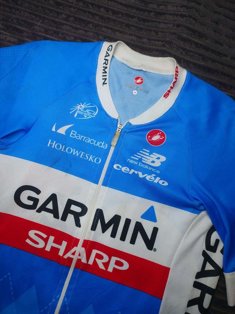 Castelli Garmin Sharp Cycling Jersey Size M (Category: Activewear) located in Manila. Submitted by norathrifted (Listing ID 1464798142, Image 3). Description: - Authentic Garmin Sharp cycling jersey made by Castelli - Size: Medium (M) - Design: Iconic blue and white argyle pattern with official sponsor logos (New Balance, Barracuda, Cervélo) - Features: Full front zipper and three convenient rear pockets - Condition: Excellent ready-to-wear condi
