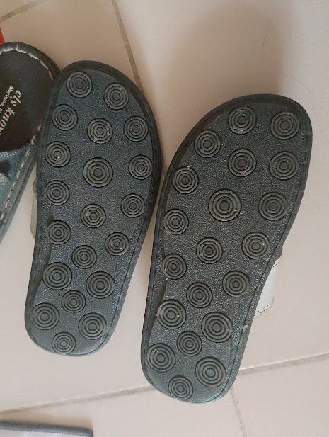 Casual Slip-on Sandals with Patterned Soles (Category: Flats & Sandals) located in Quezon City. Submitted by susmaryosep1 (Listing ID 1464898699, Image 3). Description: - Casual slip-on sandals for everyday indoor and outdoor wear - Black textured soles with circular tread patterns for better grip - Light grey upper straps accented with neat stitching details - Comfortable inner footbed with subtle heel branding - Easy to wear and style for daily