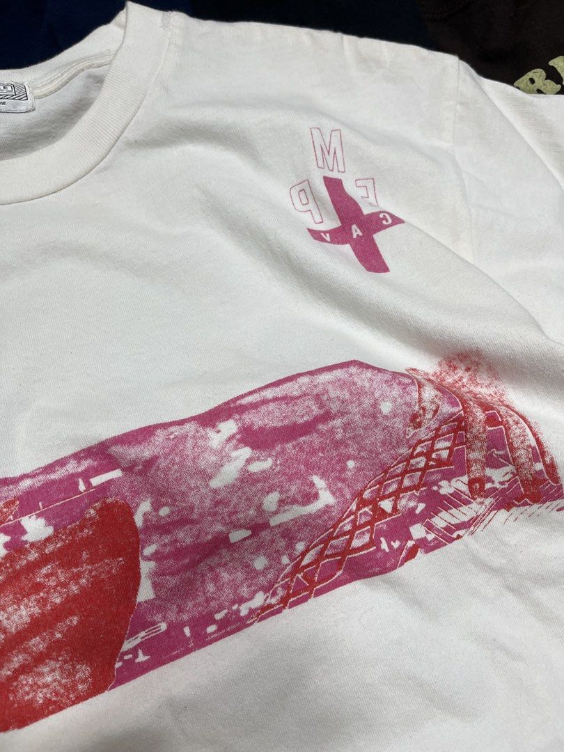 Cav Empt White Graphic Tee Size M (Category: Tshirts & Polo Shirts ) located in Baao. Submitted by plainclothesdept (Listing ID 1464780209, Image 2). Description: Cav Empt Pink Tee width - 21 in. length- 26 in. minimal discoloration near armpit - Brand: Cav Empt - Style: White graphic tee - Size: Medium - Origin: Made in Japan - Design details: Pink front chest graphic, cross branding near the collar, and 'Cav Empt' lettering down both sleeves - 