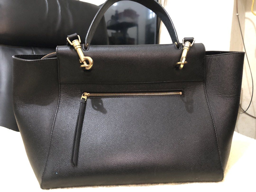 Celine Black Belt Bag (Category: Luxury Bags & Wallets) located in Cebu City. Submitted by chem83 (Listing ID 1464912656, Image 3). Description: - Material: Premium black grained leather with gold-tone hardware - Design: Signature knotted strap on front flap with clean structured shape - Closure & Pockets: Top zip closure under flap, interior slip pockets, and exterior back zip pocket - Straps: Includes a structured top handle and a removable sho