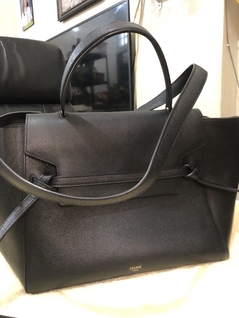 Celine Black Belt Bag (Category: Luxury Bags & Wallets) located in Cebu City. Submitted by chem83 (Listing ID 1464912656, Image 2). Description: - Material: Premium black grained leather with gold-tone hardware - Design: Signature knotted strap on front flap with clean structured shape - Closure & Pockets: Top zip closure under flap, interior slip pockets, and exterior back zip pocket - Straps: Includes a structured top handle and a removable sho