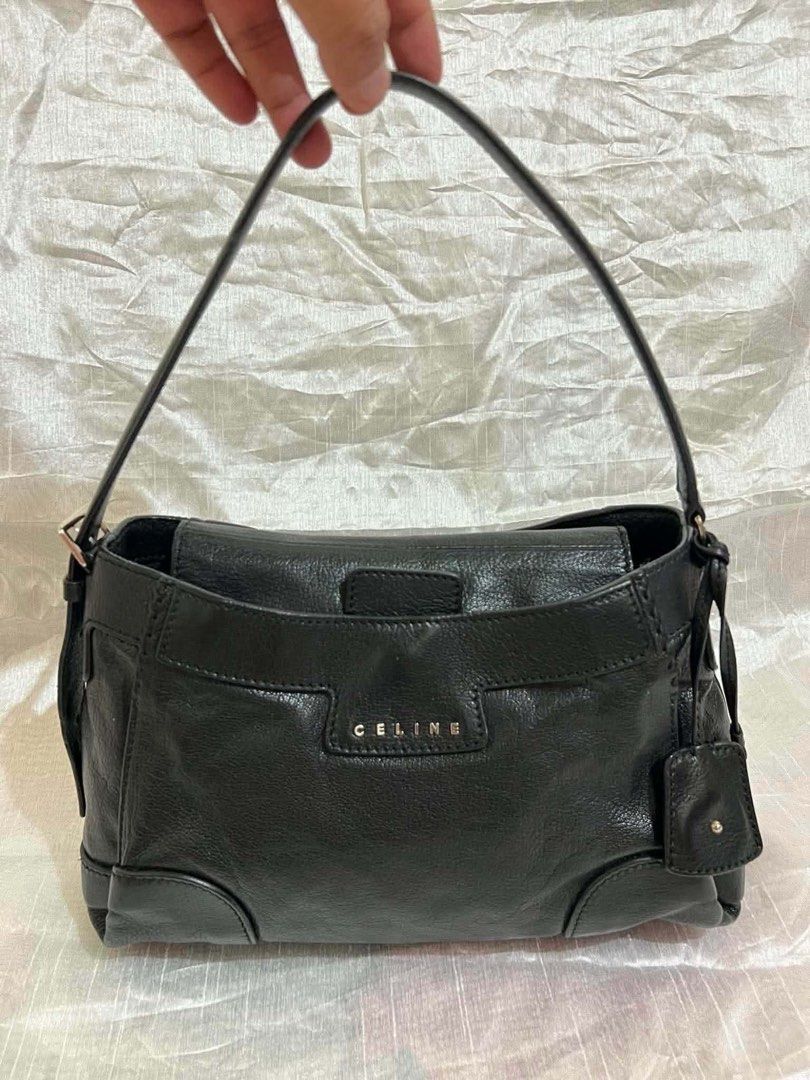Celine Black Leather Shoulder Bag (Category: Shoulder Bags) located in Quezon City. Submitted by luxuriesbymichiika (Listing ID 1464924790, Image 1). Description: - Brand: Celine - Material: Premium black leather with dark hardware - Design: Structured compact shape, single shoulder strap, and curved handle - Details: Silver front-flap lettering and a chic small hanging charm - Functionality: Secure zip closure, ideal for carrying daily essential