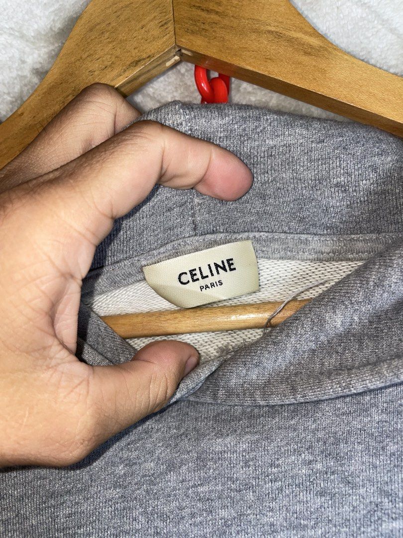 Celine Grey Hoodie Size M (Category: Hoodies) located in Molave. Submitted by charlesthrifter (Listing ID 1464896620, Image 2). Description: - Brand: Celine - Color: Grey with black chest text - Size: Medium (Regular fit) - Material: 100% Cotton - Features: Front kangaroo pocket, ribbed cuffs and hem - Origin: Made in Italy - Care: Hand wash only - Condition: Clean, excellent piece ready for the cooler weather Has issue last pic.