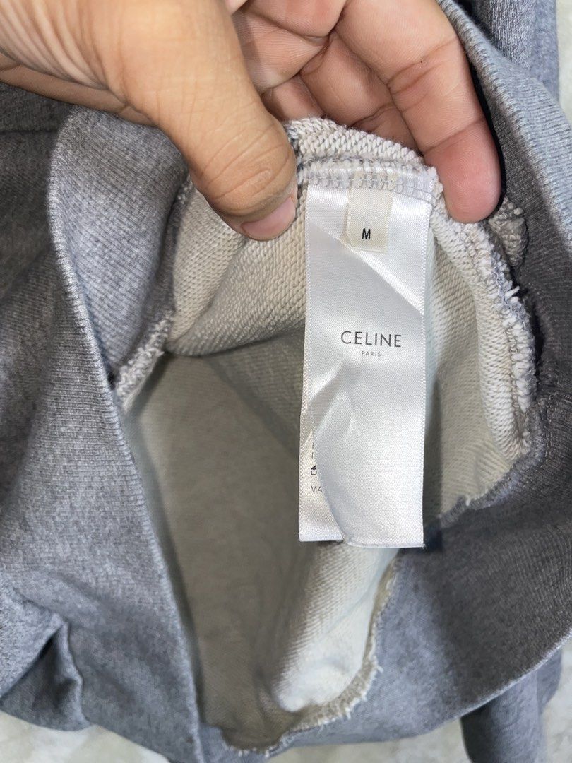 Celine Grey Hoodie Size M (Category: Hoodies) located in Molave. Submitted by charlesthrifter (Listing ID 1464896620, Image 3). Description: - Brand: Celine - Color: Grey with black chest text - Size: Medium (Regular fit) - Material: 100% Cotton - Features: Front kangaroo pocket, ribbed cuffs and hem - Origin: Made in Italy - Care: Hand wash only - Condition: Clean, excellent piece ready for the cooler weather Has issue last pic.