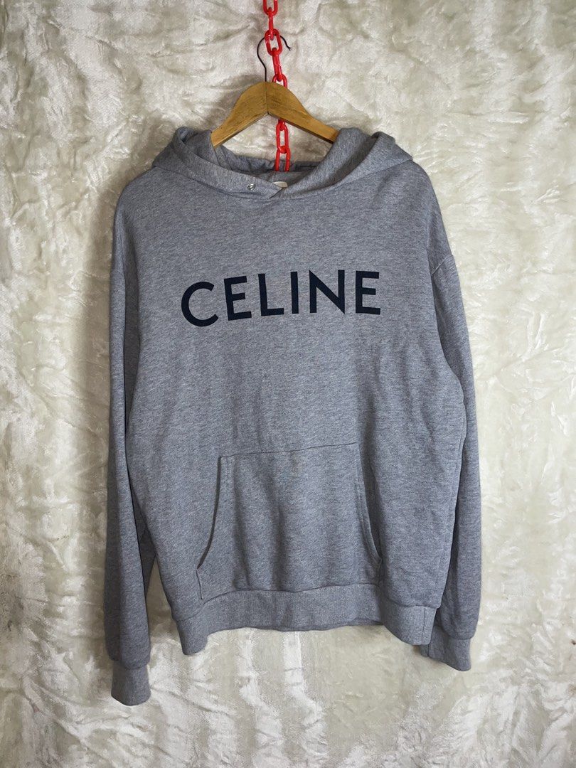 Celine Grey Hoodie Size M (Category: Hoodies) located in Molave. Submitted by charlesthrifter (Listing ID 1464896620, Image 1). Description: - Brand: Celine - Color: Grey with black chest text - Size: Medium (Regular fit) - Material: 100% Cotton - Features: Front kangaroo pocket, ribbed cuffs and hem - Origin: Made in Italy - Care: Hand wash only - Condition: Clean, excellent piece ready for the cooler weather Has issue last pic.