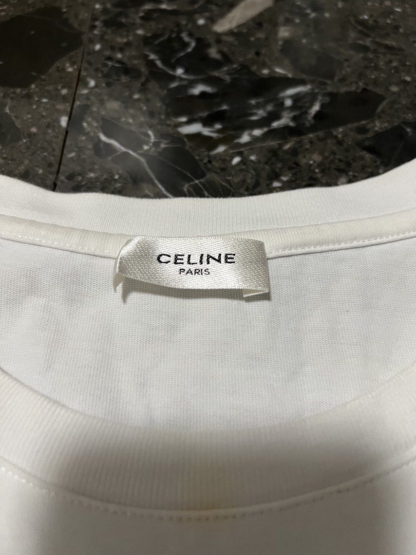 Celine Paris Gradient Logo White T-Shirt Size M (Category: Shirts) located in San Fernando. Submitted by justin_sy (Listing ID 1464887735, Image 3). Description: - Brand: Celine Paris - Color: Crisp white with metallic pink-to-green gradient graphic - Size: M (verified via inner tags) - Material: Premium cotton with a clean finish - Design: Short sleeves, classic crew neck, and raised white Celine lettering - Condition: Excellent, clean fabric.