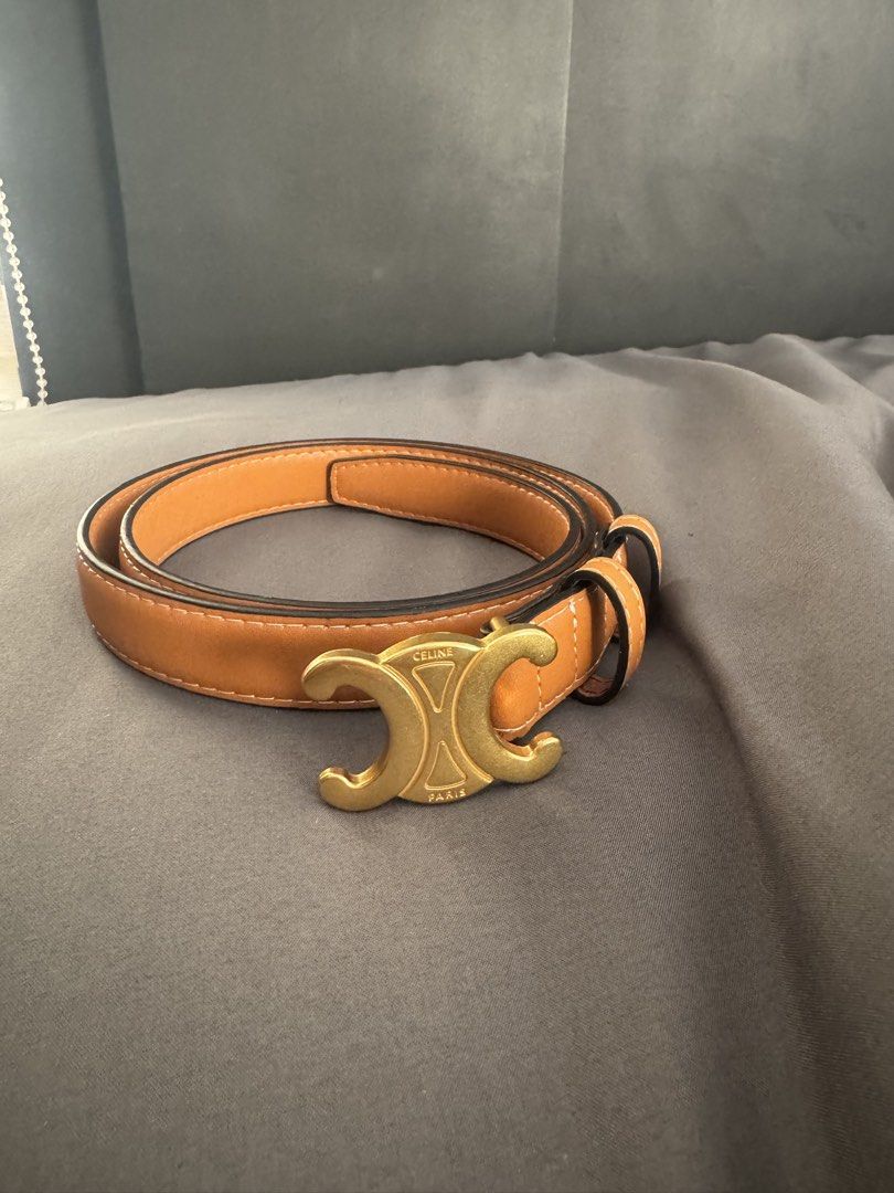 Celine Triomphe Tan Leather Belt Size 105 (Category: Belts) located in Rizal. Submitted by thrifty.mom (Listing ID 1464793499, Image 1). Description: - Brand: Celine - Material: Tan leather with white contrast stitching - Hardware: Gold-tone Triomphe buckle - Size: 105 (Made in Italy) - Fit: Adjustable with multiple punch holes - Condition: Clean, minimal wear on strap and hardware Preloved thrift sourced No guarantee no inclusions.