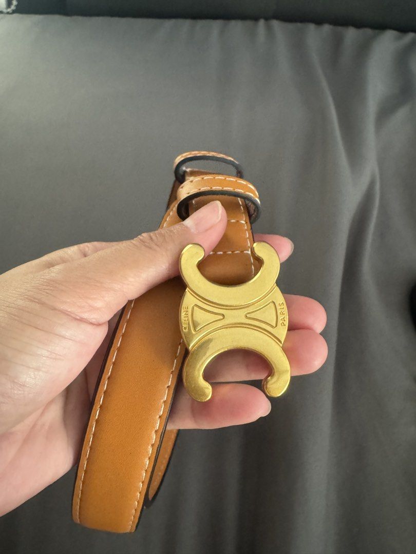 Celine Triomphe Tan Leather Belt Size 105 (Category: Belts) located in Rizal. Submitted by thrifty.mom (Listing ID 1464793499, Image 2). Description: - Brand: Celine - Material: Tan leather with white contrast stitching - Hardware: Gold-tone Triomphe buckle - Size: 105 (Made in Italy) - Fit: Adjustable with multiple punch holes - Condition: Clean, minimal wear on strap and hardware Preloved thrift sourced No guarantee no inclusions.