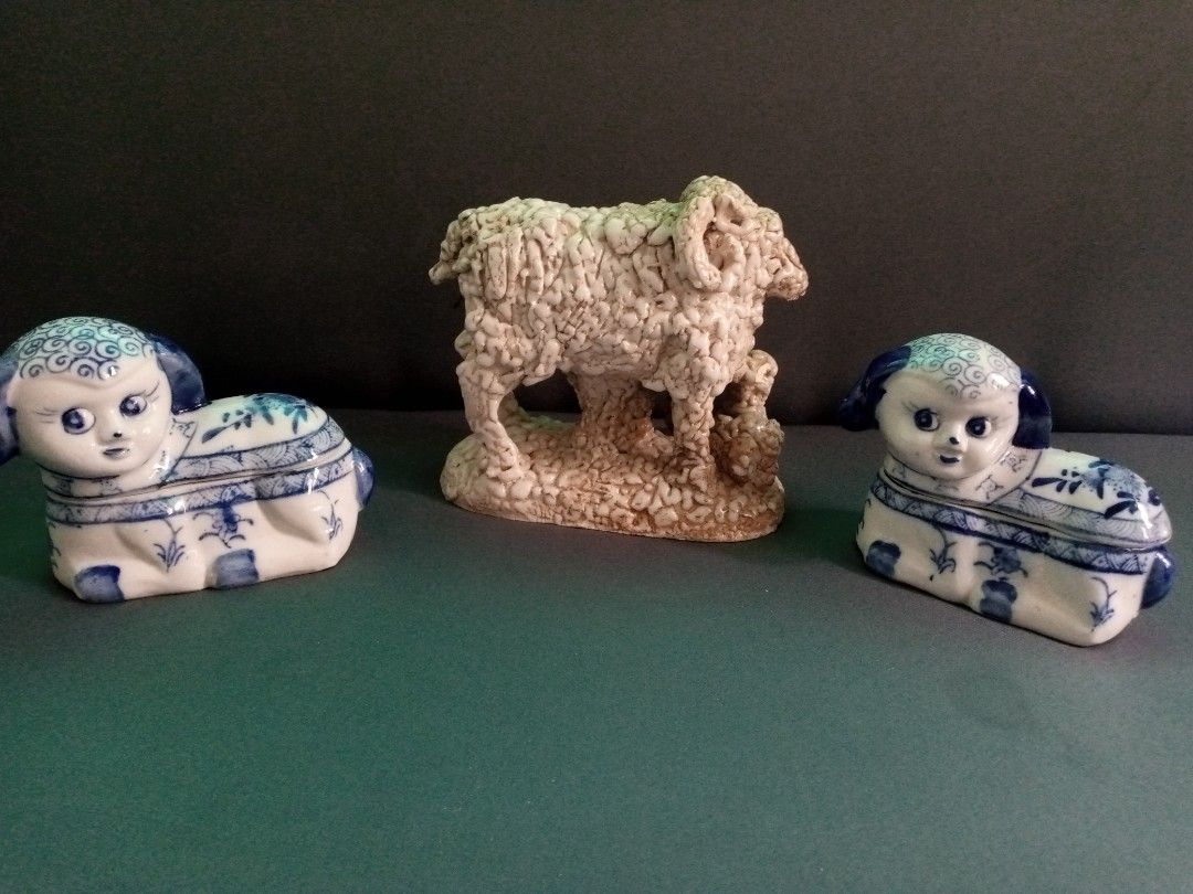 Ceramic sheep figurine set with two blue and white trinket boxes (Category: Figurines & Statues) located in General Trias. Submitted by dwyane09 (Listing ID 1464818119, Image 2). Description: - 3-piece ceramic sheep decor set - Centerpiece: Textured off-white sheep with a little lamb - Side pieces: 2 blue and white porcelain resting lamb trinket boxes with human-like faces and detailed painted fleece - Ideal for shelf displays, home decor, or col