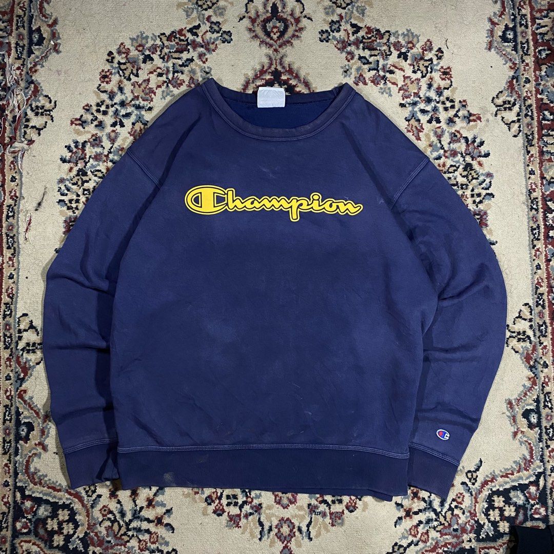 Champion Navy Blue Yellow Script Logo Crewneck Sweatshirt (Category: Coats, Jackets and Outerwear) located in Manila. Submitted by thrifturfit_star (Listing ID 1464941253, Image 1). Description: - Brand: Champion - Color: Navy blue with large yellow embroidered chest script - Size: Large - Material: Heavyweight cotton fleece - Details: Classic ribbed cuffs and hem, iconic C logo on left wrist, blank white neck tag - Condition: Excellent streetwea