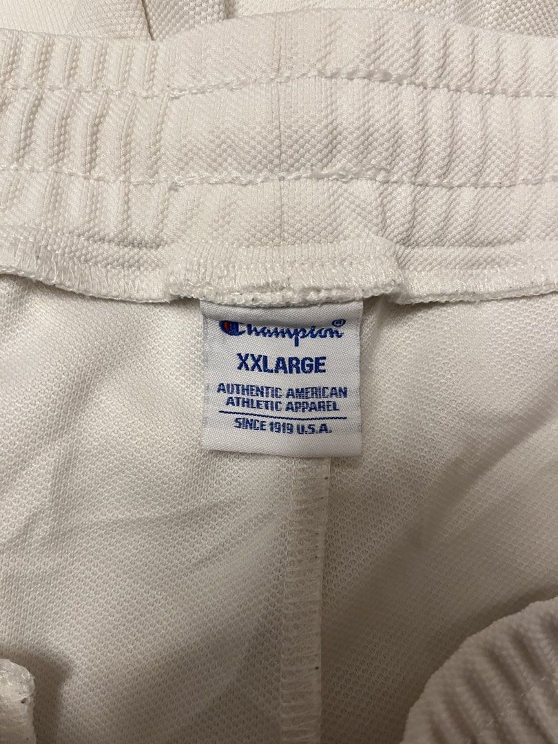 Champion White Athletic Shorts XXL (Category: Shorts) located in Calasiao. Submitted by cristinabarongan5 (Listing ID 1464835945, Image 3). Description: - Brand: Champion - Color: White with black & white striped cuffs - Size: XXL - Material: 100% nylon body, 100% cotton lining - Features: Elastic waistband, adjustable drawstring, dual side logos, and vertical script logo - Origin: Made in Vietnam - Condition: Clean and ready to wear - Size 32-38