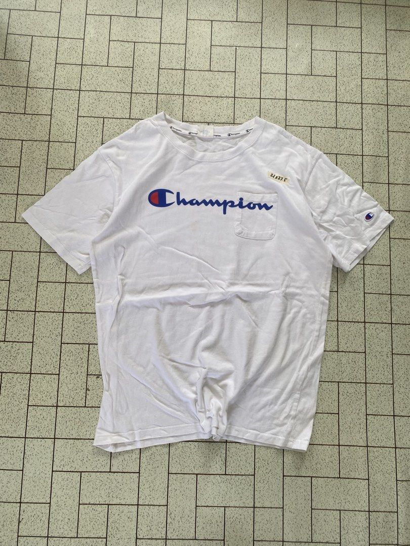 Champion White Script Logo Pocket T-Shirt X-Large (Category: Tshirts & Polo Shirts ) located in Manila. Submitted by sepamorash53558 (Listing ID 1464807467, Image 1). Description: - Brand: Champion - Color: White - Size: X-Large (XL) - Features: Large blue script logo, chest pocket, left sleeve embroidered patch, and branded inner collar tape - Measurements: ~21" pit-to-pit, ~27.5" length - Condition: Excellent.