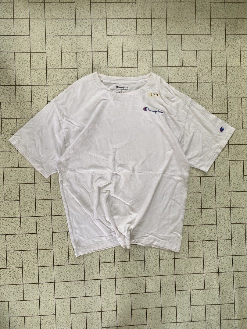 Champion White T-Shirt Size L (Category: Tshirts & Polo Shirts ) located in Manila. Submitted by sepamorash53558 (Listing ID 1464806985, Image 1). Description: - Brand: Champion - Color: White - Size: Large - Material: 100% cotton (Made in Indonesia) - Design: Classic crewneck with small embroidered script logo on chest and C logo patch on left sleeve - Pit to Pit: 21 inches - Length: 27 inches.