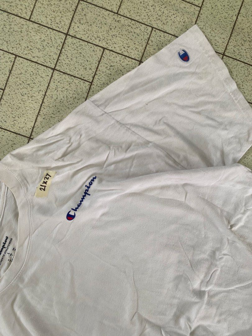 Champion White T-Shirt Size L (Category: Tshirts & Polo Shirts ) located in Manila. Submitted by sepamorash53558 (Listing ID 1464806985, Image 2). Description: - Brand: Champion - Color: White - Size: Large - Material: 100% cotton (Made in Indonesia) - Design: Classic crewneck with small embroidered script logo on chest and C logo patch on left sleeve - Pit to Pit: 21 inches - Length: 27 inches.