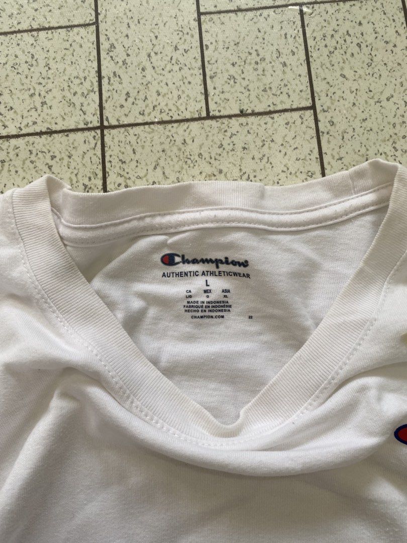 Champion White T-Shirt Size L (Category: Tshirts & Polo Shirts ) located in Manila. Submitted by sepamorash53558 (Listing ID 1464806985, Image 3). Description: - Brand: Champion - Color: White - Size: Large - Material: 100% cotton (Made in Indonesia) - Design: Classic crewneck with small embroidered script logo on chest and C logo patch on left sleeve - Pit to Pit: 21 inches - Length: 27 inches.
