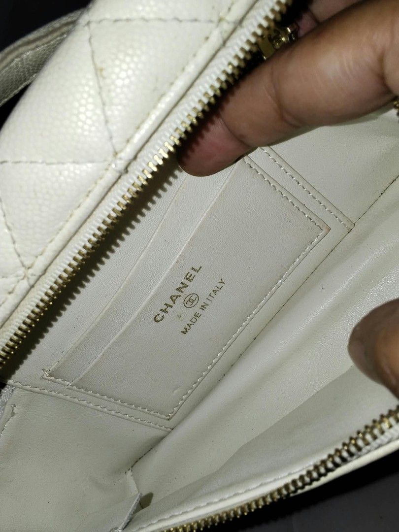 Chanel Quilted Caviar Vanity Bag with Chain (Category: Cross-body Bags) located in Manila. Submitted by bagelyascollection (Listing ID 1464878021, Image 3). Description: - Authentic Chanel Vanity Bag - Material: White quilted caviar leather - Hardware: Gold-tone with CC logo on front and zipper pull - Straps: Top handle and intertwined leather/chain strap - Interior: Matching lining with Chanel stamp, Made in Italy stamp, and matching serial numb