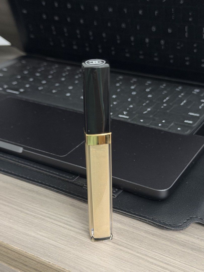Chanel Rouge Coco Gloss 712 (Category: Makeup) located in Manila. Submitted by karminareyes123 (Listing ID 1464921399, Image 1). Description: - Brand: Chanel - Product: Rouge Coco Gloss - Shade: 712 - Size: 5.5g / 0.19 oz - Origin: Made in France - Packaging: Classic black cap with white interlocking CC logo, clear tube showing golden shimmer - Applicator: Standard wand - 100% authentic and well-maintained.