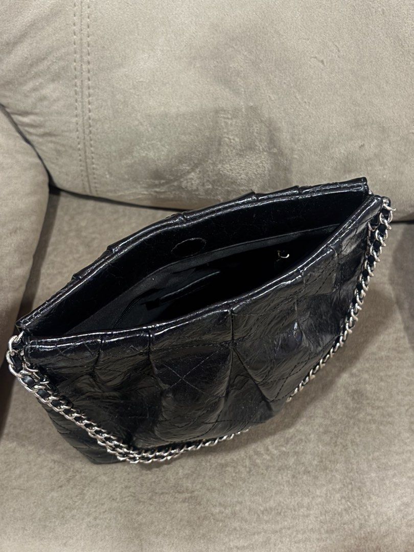 Charles & Keith Black Quilted Chain Shoulder Bag (Category: Shoulder Bags) located in Andop. Submitted by pinkmatcha0715 (Listing ID 1464962610, Image 3). Description: - Brand: Charles & Keith - Style: Shoulder bag with edgy crinkled patent finish and quilted pattern - Straps: Double chain strap woven with black material - Hardware: Silver-toned with subtle stamped logo near the base - Interior: Open top design with an internal zip pocket lining 