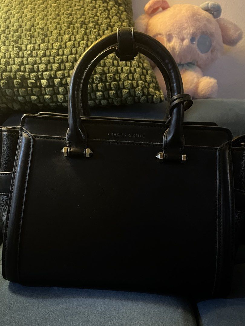 Charles & Keith Black Structured Handbag (Category: Luxury Bags & Wallets) located in Quezon City. Submitted by emimichii (Listing ID 1464945899, Image 3). Description: -signs of wear and scratches, i think it can be fixed with leather care -still sturdy -rfs: declutter, no use anymore .