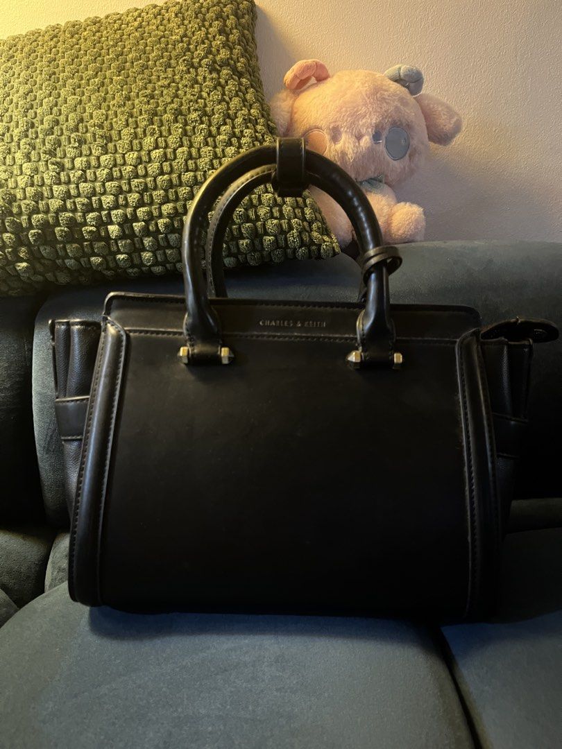 Charles & Keith Black Structured Handbag (Category: Luxury Bags & Wallets) located in Quezon City. Submitted by emimichii (Listing ID 1464945899, Image 1). Description: -signs of wear and scratches, i think it can be fixed with leather care -still sturdy -rfs: declutter, no use anymore .